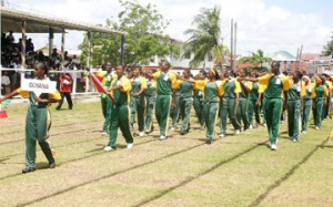A confident-looking Guyana team marching past the main pavilion at the Eve Leary ground yesterday to a standing ovation. (Orlando Charles photo)    
