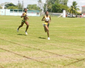 Home Alone! Guyana&#8217;s Jevina Straker (R) and Janella Jonas (L) storm home unchallenged in their IGG 1500m race at the Eve Leary Sports Complex ground, yesterday. (Orlando Charles photo)   