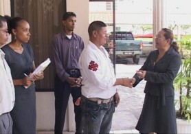 Minister of Amerindian Affairs Pauline Sukhai (right) hands over the tractor keys to Toshao, James Cornelius of Karrau, Region 7. (GINA photo)  