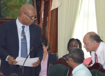 Minister in the Ministry of Finance Juan Edghill conferring in Parliament today. NCN Head Mohamed Sattaur is at right.